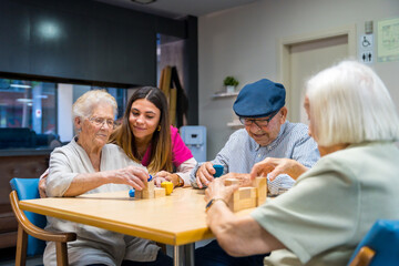 Elderly people in a nursing home sharing skills games