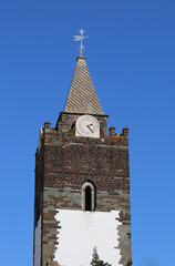 Old Historic Clock Tower with Cross Weather Vane on Top in Funchal, Madeira, Portugal