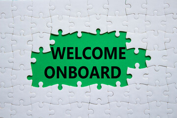 Welcome onboard symbol. Concept words Welcome onboard on white puzzle. Beautiful green background. Business and Welcome onboard concept. Copy space.