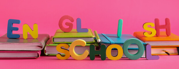 Many books and text ENGLISH SCHOOL on pink background