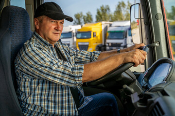 Closeup shot, amazing lighting, trucker sitting in front of wheel ready to start his day, parked...
