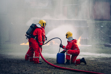 Fearless Firefighters Battling Blaze with Water and Extinguishers. Firefighters in Action,...