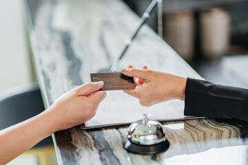 Guest Customer paying for services in hotel with card.