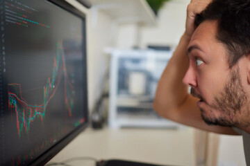 Focused business man trader analyst looking at computer monitor, investor broker analyzing indexes
