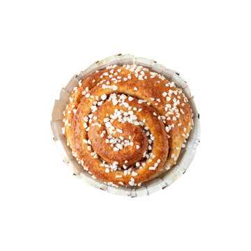 Freshly baked cinnamon bun in paper form closeup isolated on white. Traditional swedish sweet pastry kanelbulle.
