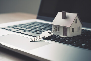 A miniature house on top of a laptop keyboard, next to home keys, protect your property, safeguard your privacy, ensure data and online security.