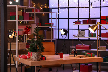 Interior of modern post office with Christmas tree and desk