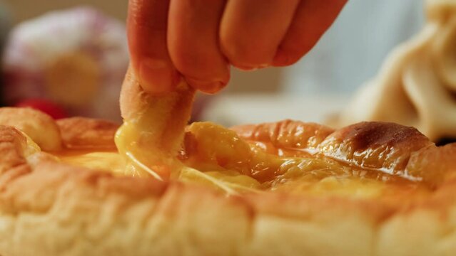 Adjarian khachapuri pastry pie with cheese and raw yolk, Traditional georgian cuisine. Khachapuri with egg on wooden background in rustic style. Tbilisi food
