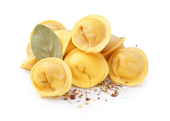 Yellow raw dumplings with spices and bay leaf on white background