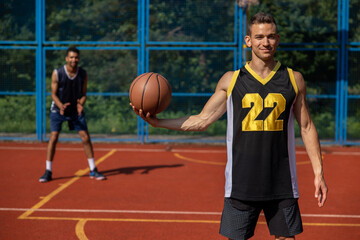 Naklejka premium Two street basketball players playing on court.