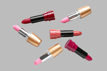Obraz premium Lipsticks flying on grey background