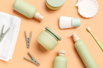 Composition with different cosmetic products and clothespins on color background