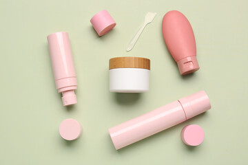 Composition with different cosmetic products on green background