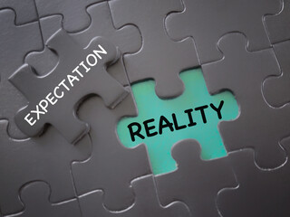 Social and media issue. EXPECTATION and REALITY written on jigsaw puzzle pieces. With blurred...