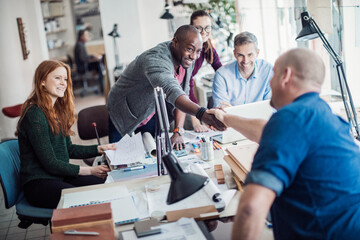 Group of people working together on a project in a startup company office