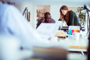Diverse pair of architects working on a project in a modern office