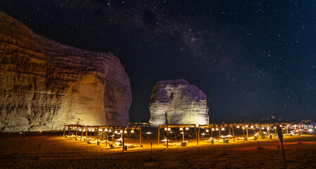 Illuminated outdoor lounge in front of elephant rock erosion monolith standing in the night...
