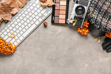 Composition with female accessories, keyboard, eyeshadows and rowan berries on grunge background - obrazy, fototapety, plakaty