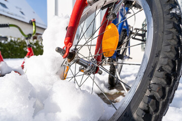 Wheel of children's mountain bike with snow in winter 