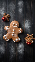 Christmas gingerbread man on black background, top view with copy space.