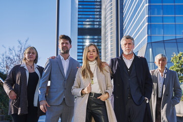 Portrait of successful group of business people looking at camera. Portrait of happy businessmen and satisfied businesswomen standing as a team. Multiethnic group of people