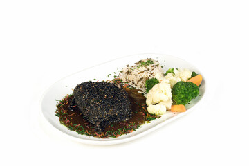 Chicken breast covered with mole and sesame seeds with rice and vegetables, Mexican food on white background