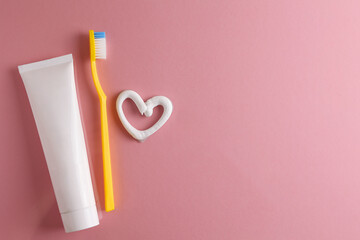 Toothpaste heart on a colored background. Dental care, oral health. - obrazy, fototapety, plakaty