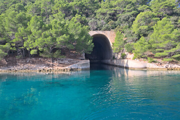 Submarine and ship bunker on Lastovo island, Croatia. Concrete bunker shelter for submarines in adriatic sea. Travel on a yacht in Croatia. - 667301735