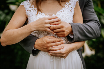 The bride wears a wedding ring to the groom at the wedding ceremony. Hand in hand. Wedding,...