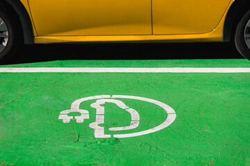 Electric car charger sign on ground