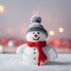 Obraz premium Cute snowman wearing red scarf on a snowy area and bokeh light background
