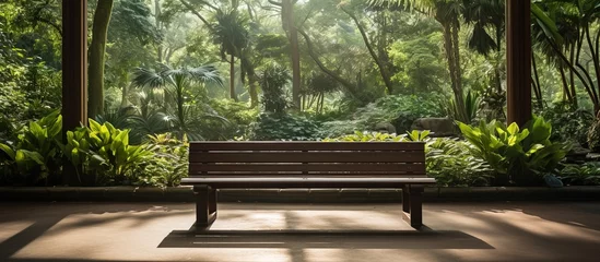 Fotobehang Wooden bench in the indoor park at Flora garden © Vusal