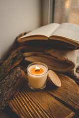 Burning candle in home interior, autumn aesthetics