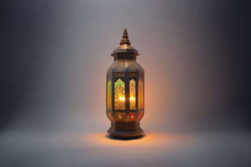 An ornamental Arabic lantern with colorful glass glowing on a studio background, a greeting for Ramadan and Eid.
