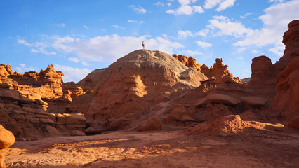 Hiker standing on a hill at Goblin Valley in Utah, USA