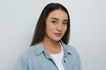 Fototapeta premium Portrait of beautiful young woman in jeans jacket on white background