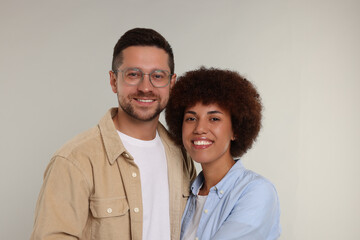 International dating. Portrait of happy couple on light grey background