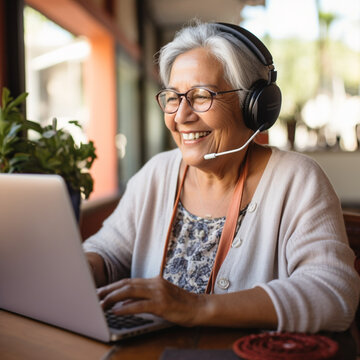 Elderly Latin Mexican woman communicates or learns something online and is happy, which shows us that one can always learn something