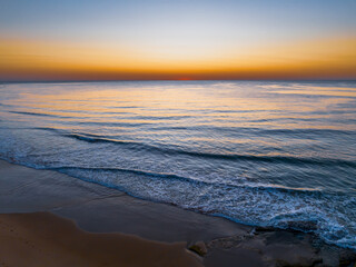 Aerial sunrise seascape with a hazy sky from fire reduction burnoffs