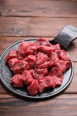 Pieces of raw beef meat on wooden table