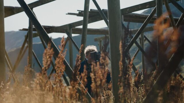 Videographer Filming Near Stockfish Structure
