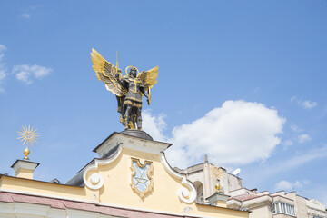 a historical statue of man with wings on the gate of maidan square in capital kyiv