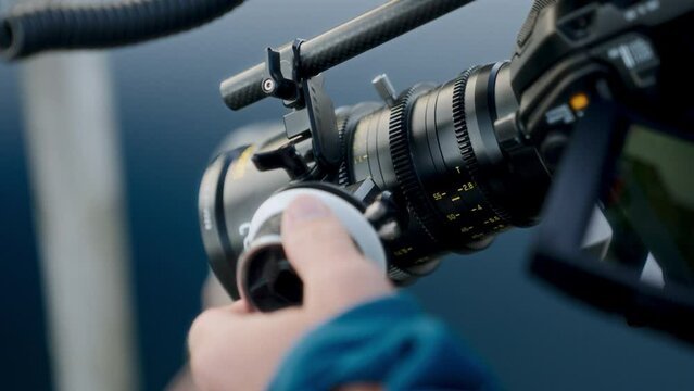 A Hand Fine-tuning The Camera Lens