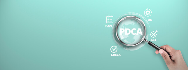 PDCA – Plan Do Act Check in Business and Technology for Continuous Improvement. Magnifier focus...