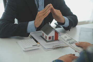 Real estate agent and customer signing contract to buy house, insurance or loan real estate.rent a...