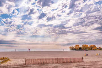 expansive sand beach ashbridges bay in toronto with  snow fencing in the foreground and a vast...