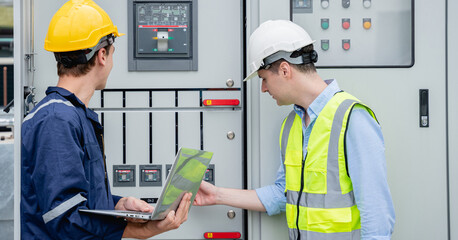 A team of engineers examined the electrical switchboard while checking the operational voltage...