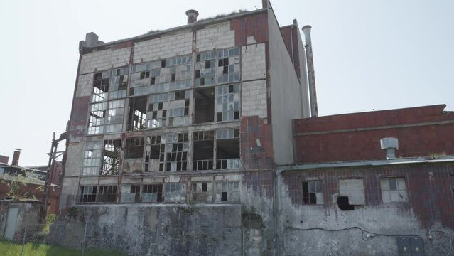 large, ruined building with broken windows. The building is in a rural area of Cukrownia Żnin in Poland. Pannin left shot.