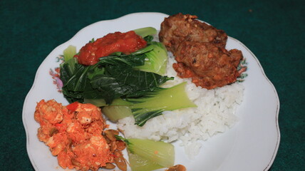 white rice, fresh mustard greens with a side dish of tempeh