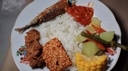 white rice with side dishes of fried salted fish and tamarind vegetables